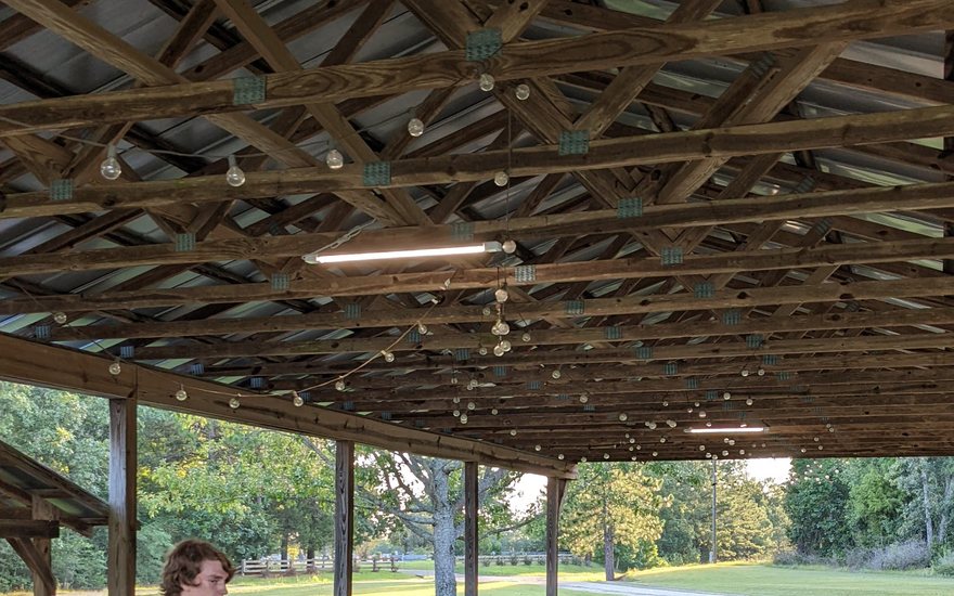 The pavilion in the evening with an LED fixture lit on the ceiling